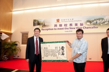 The President of CUHK Student Union (right) presents a souvenir to Professor Joseph Sung