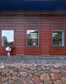 With a simple timber-trellis cladding design, this modern building blends in with the rural ambiance of the village