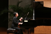 Dr. Lam Bun-ching delivers a lecture on 'River Flows, Moon Moves Stone: Poetry - Images - Music' and performs a piece of music.