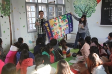 CUHK students teach local kids how to play with the toys.