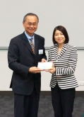 Prof. Fok Tak Fai, Pro-Vice-Chancellor of CUHK (left) presents a souvenir to Miss Kitty Liu, Charities Manager of The Hong Kong Jockey Club.