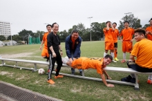 Prof. Joseph Sung provides a massage for a player after the game.