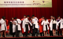 White coats are solemnly conferred on over 200 newly admitted medical students by Dr. KO Wing Man, Secretary for Food and Health, the HKSAR Government (middle, back row); Dr HUNG Chi Tim, Cluster Chief Executive, New Territories East Cluster, Hospital Authority (2nd right, back row); and Prof. Francis CHAN, Dean of the Faculty of Medicine, CUHK (3rd left, back row), in the White Coat Inauguration Ceremony.