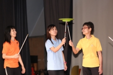 Colleagues perform Chinese acrobatics on stage.