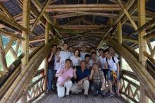 Prof Edward NG (middle, front row), Yao Ling Sun Professor of Architecture, CUHK; Prof YANG Jun (left, front row), Tsinghua University; Prof XIANG Zhongfu (right, front row), Chongqing Jiaotong University;  Xavier Pino (middle, back row), Columbian architect; and student volunteers from Chongqing Jiaotong University pose for a photo on the modern bamboo bridge ‘Yi Xin Qiao’.