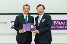 Prof. Benjamin Wah, Provost of CUHK (right) presents a souvenir to Mr. Mo-po Paul Chan, Financial Secretary of the Hong Kong SAR Government.