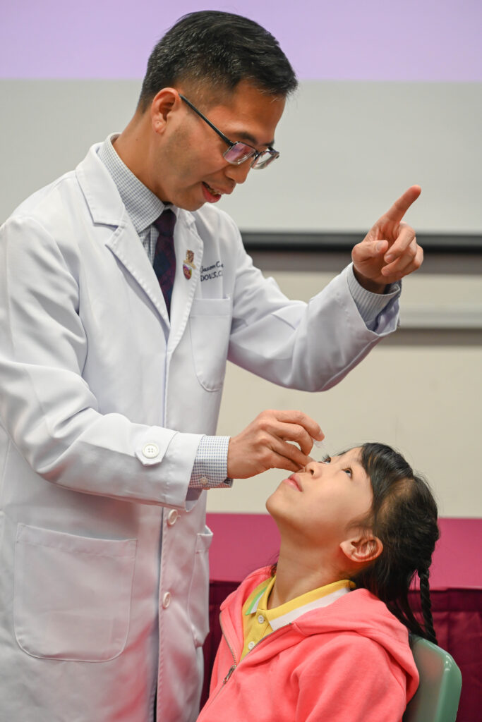 Demonstration of the application of low-concentration 0.05% atropine eyedrops.