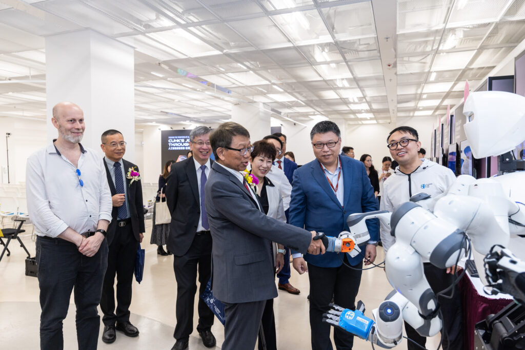 CUHK Vice-Chancellor and President Professor Rocky S. Tuan shakes hands with the CURI humanoid robot developed by the CLOVER lab.